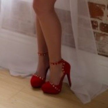 Worn sexy red studded stiletto heels
