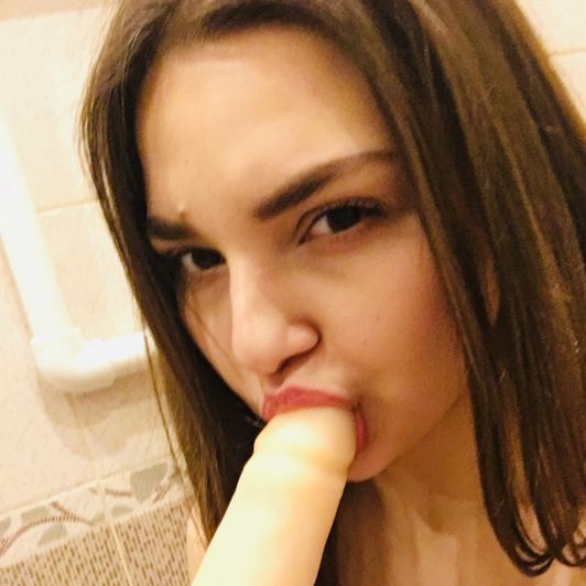 Stretching mouth and cheeks with dildo