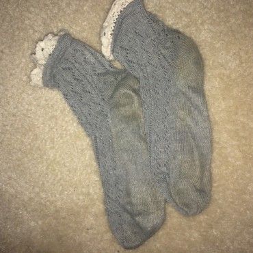 Worn grey socks with white lace trimming
