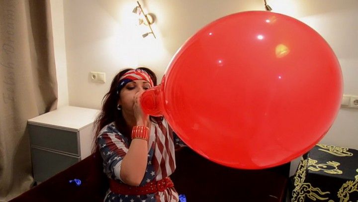 Nathalie Blows To Pop Red Balloon