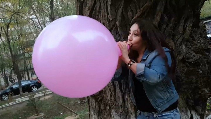 Nathalie Blows To Pop Pink Balloon
