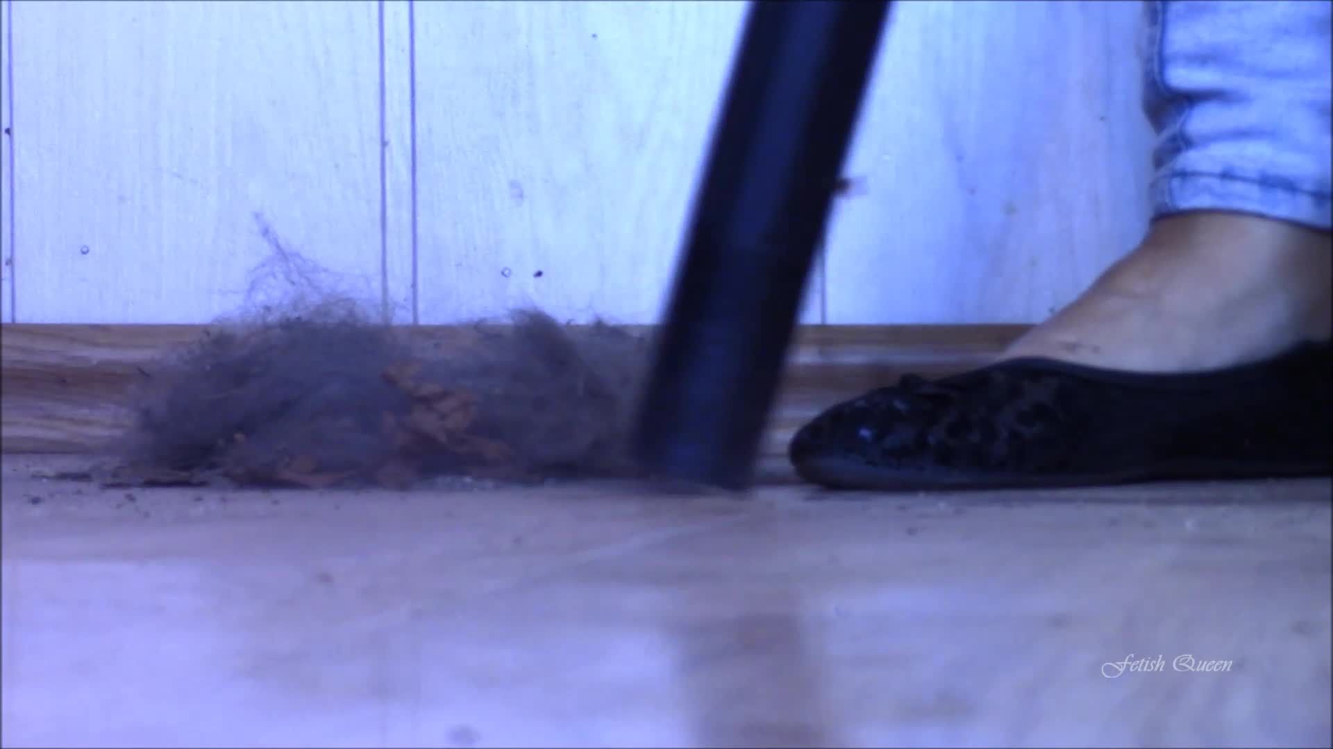Vacuuming rubbish in black ballet flats