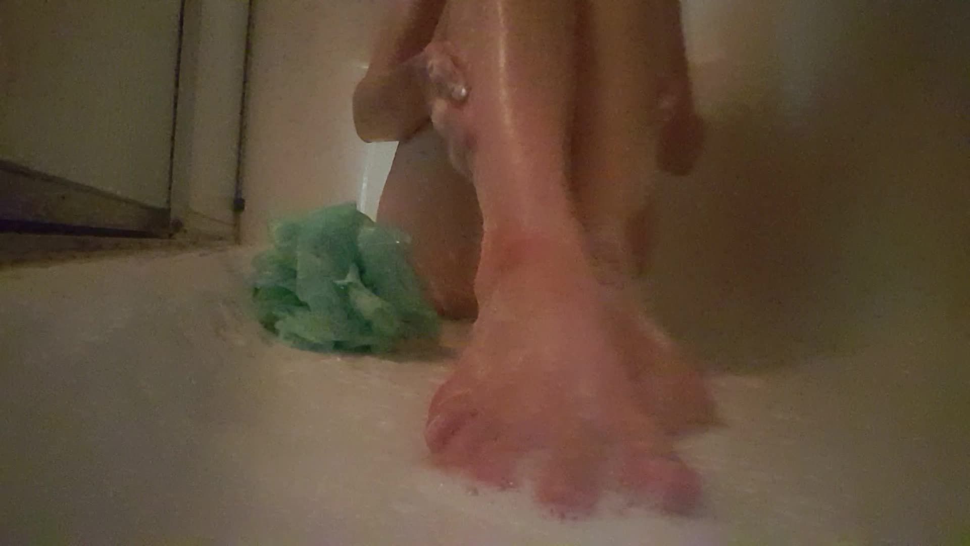 Naked feet play in the shower