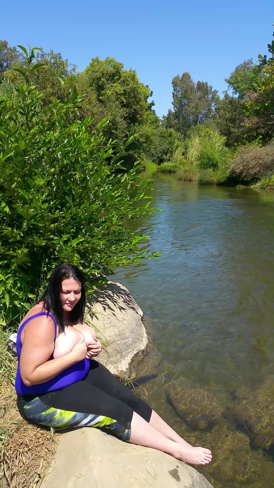 Playing with my G cup breast at a creek