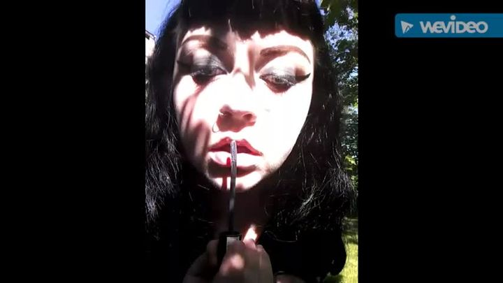 Goth Goddess Applying Black Lipstick