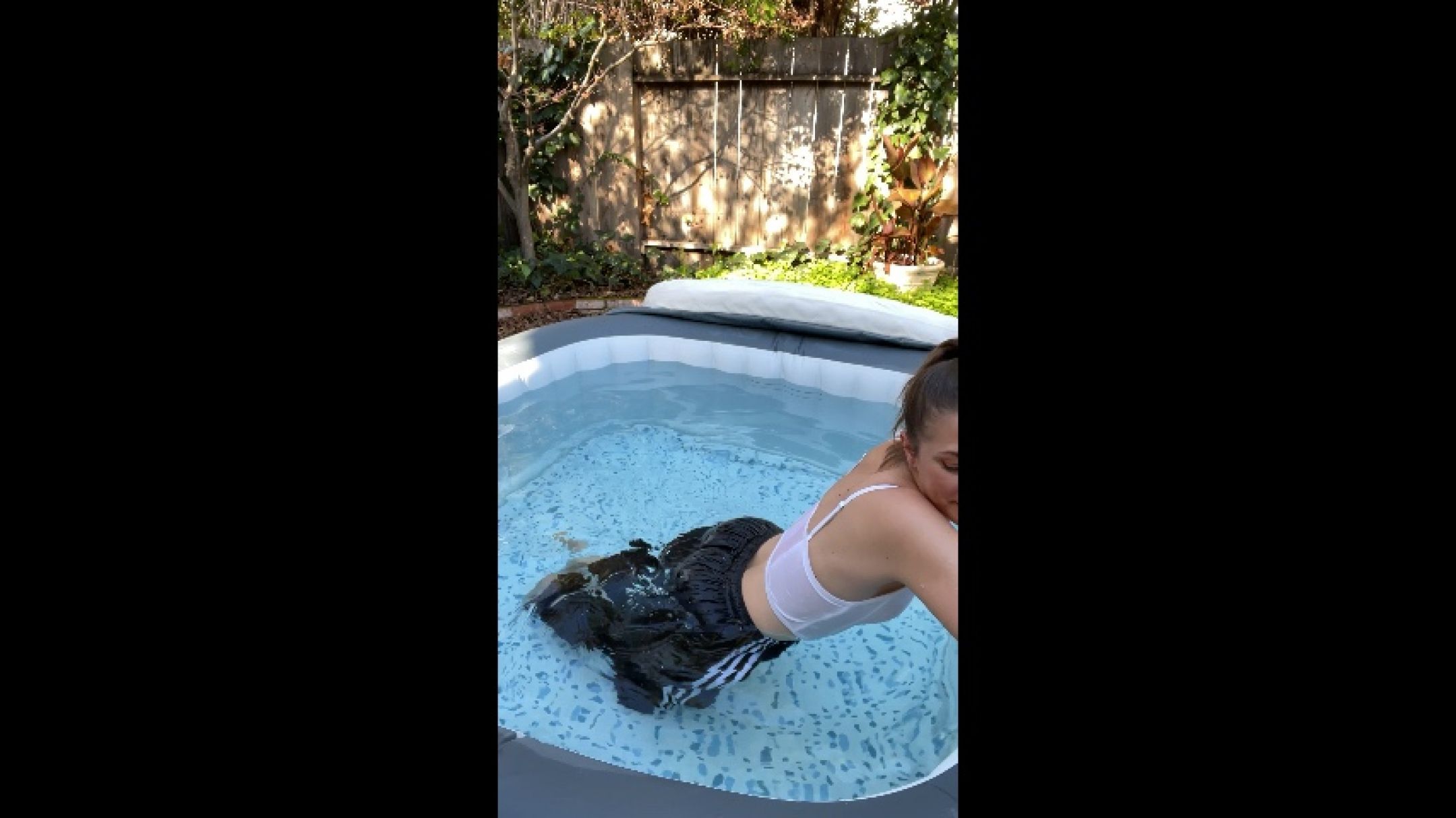 Splish splash in hot tub wearing swishy pants