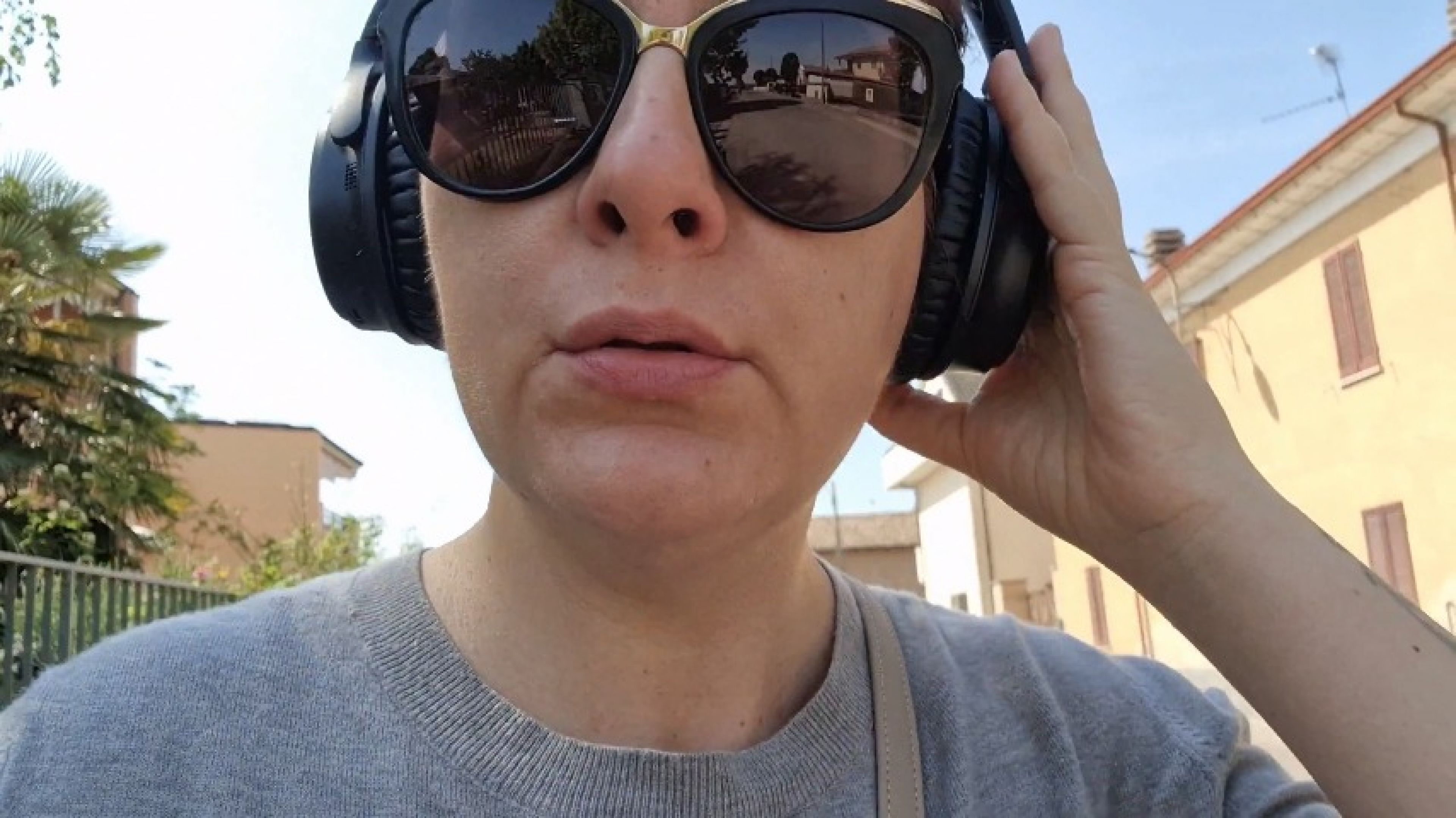 Sneezing on the street wearing my Bose headphones