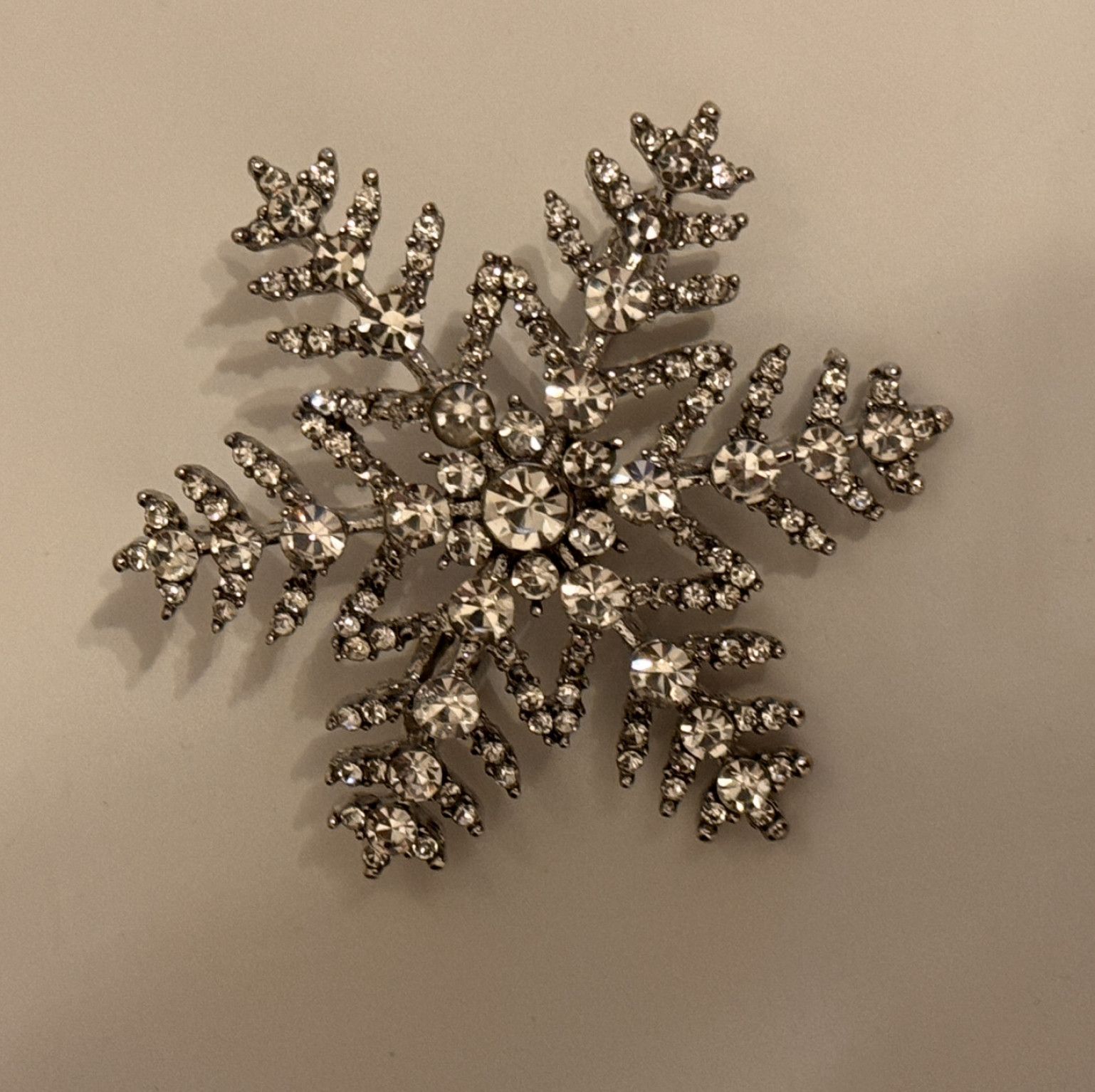 Metal snowflake brooch