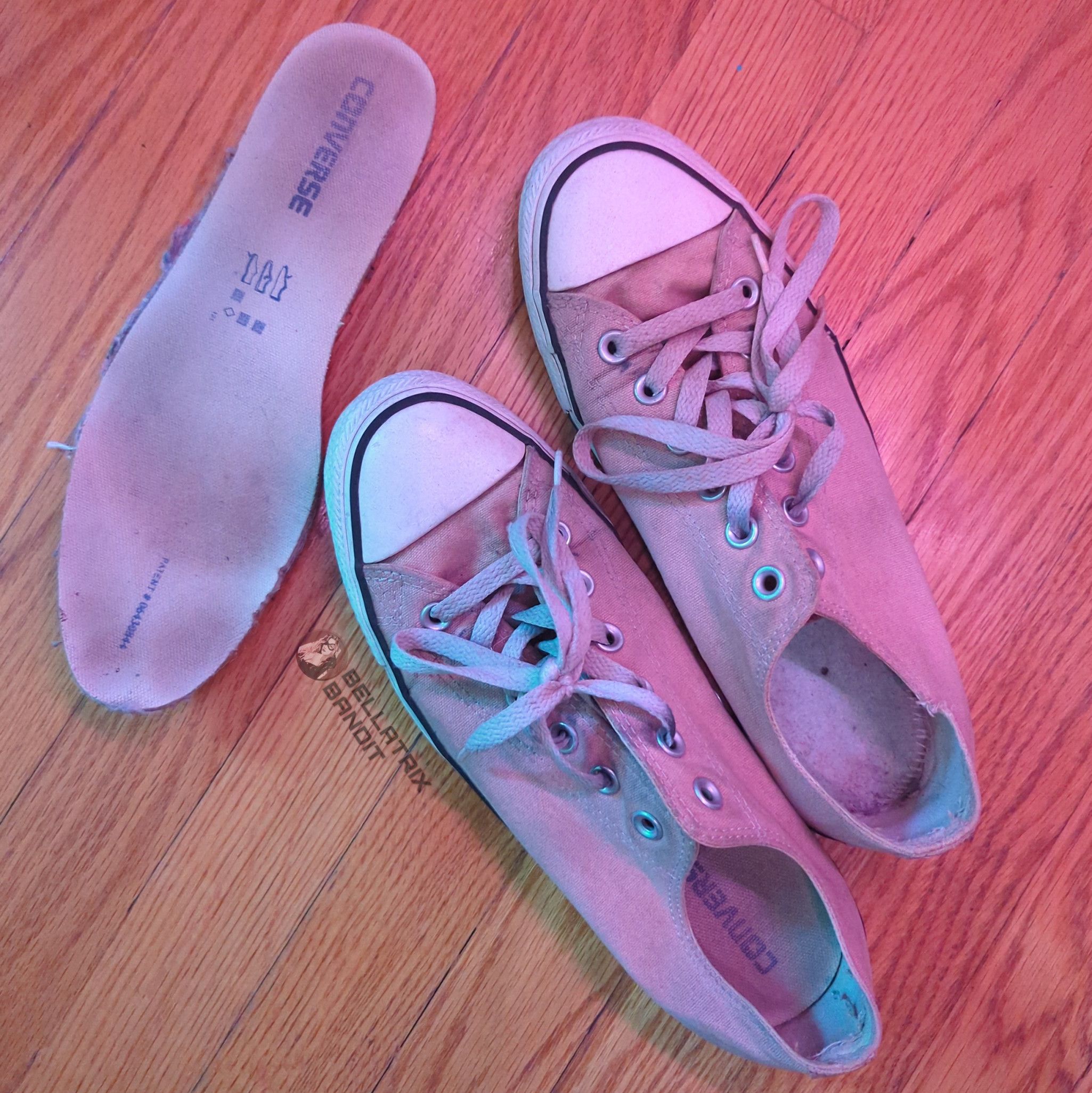 Dirty worn out old pink converse sneakers