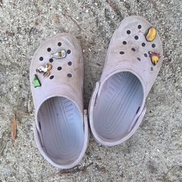 Worn Purple Crocs with Charms