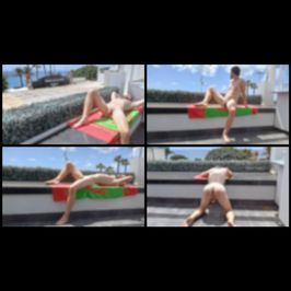 A boy sunbathes naked on a private terrace