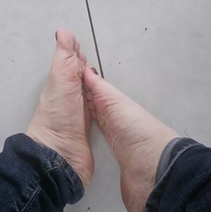 Feet red polish nail