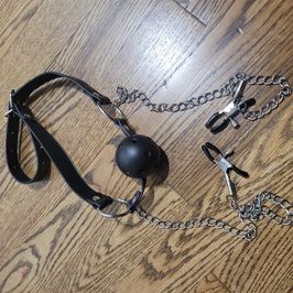 Worn Ball Gag with Chained Nipple Clamps