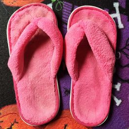 worn fuzzy slippers with foot print