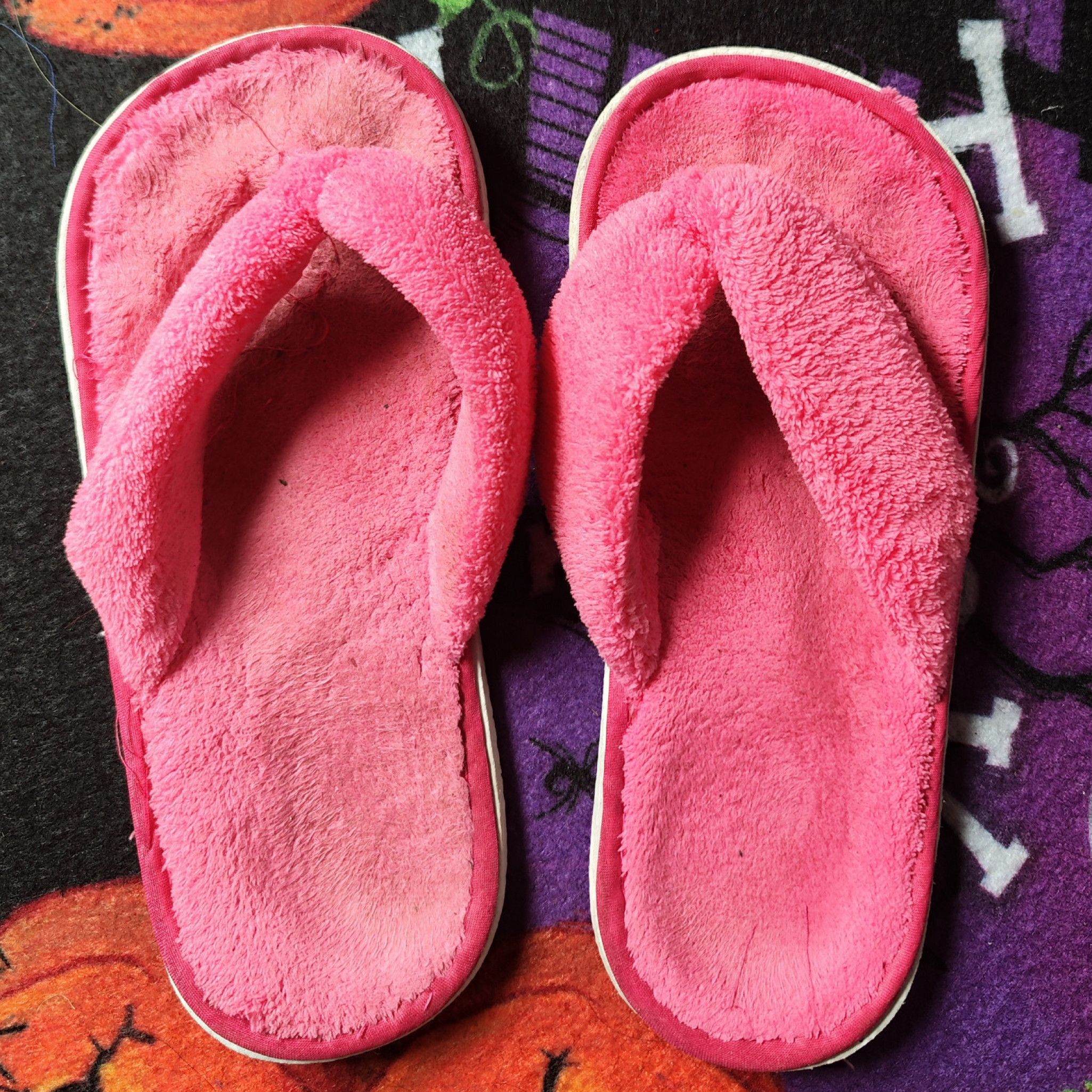worn fuzzy slippers with foot print