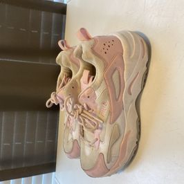 WORN PINK AND WHITE FILAS