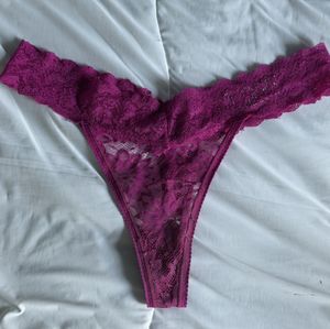 Pink lace thong worn