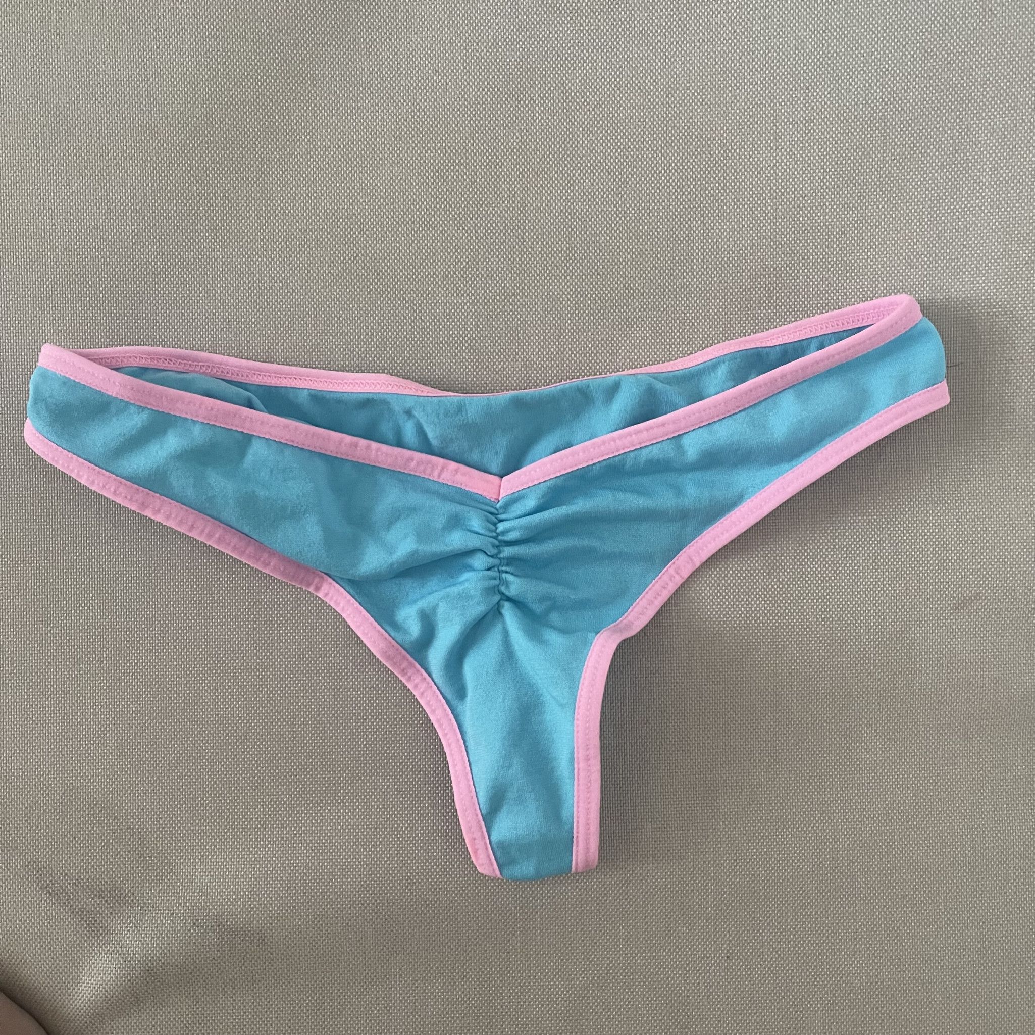 worn blue and pink ruched thong