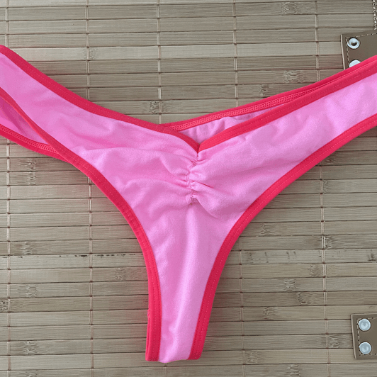 worn neon pink ruched cheeky thong