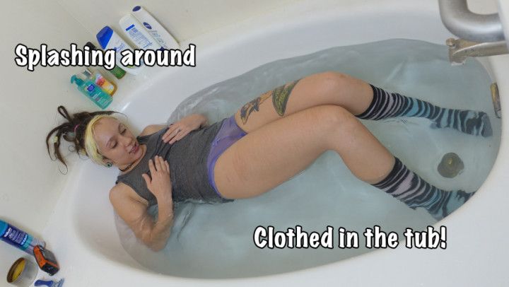 Fully clothed wetlook splashing around