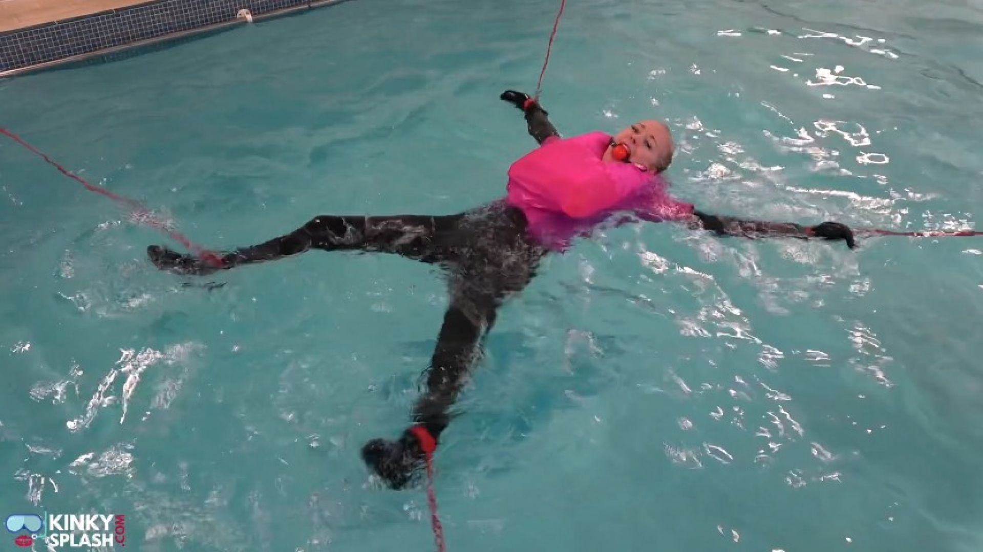 Neoprene Brat in the Pool: Tied Spreadeagle in Inflateable