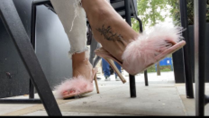 Heeled mules dangling outdoors