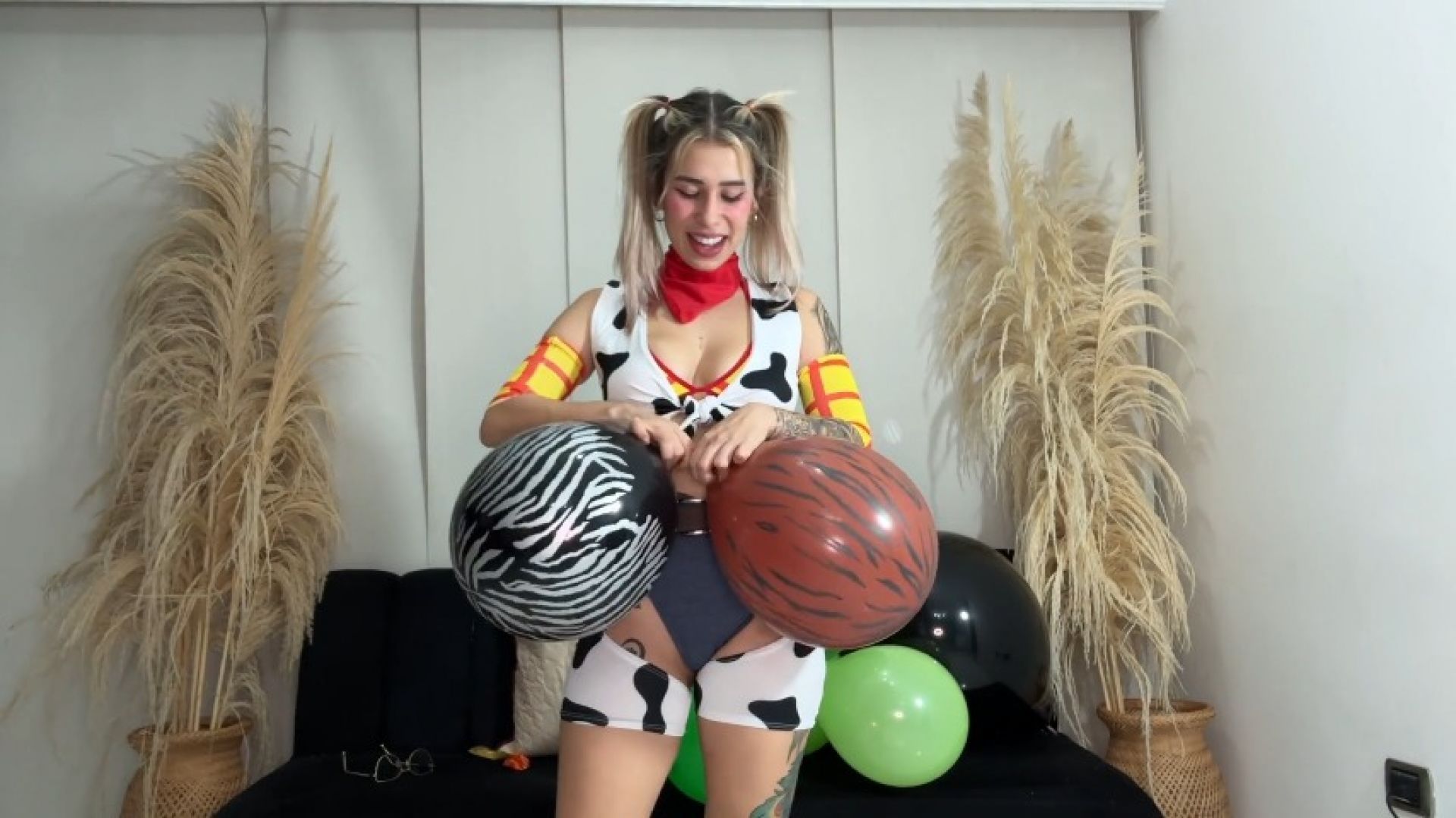 Cute cowgirl playing with balloons