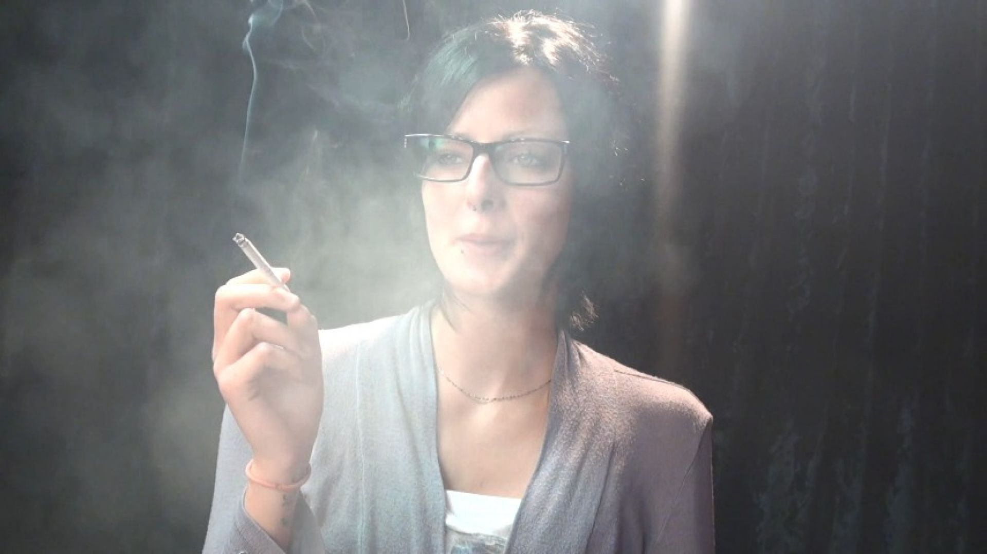 a smoking and coughing tall skinny woman