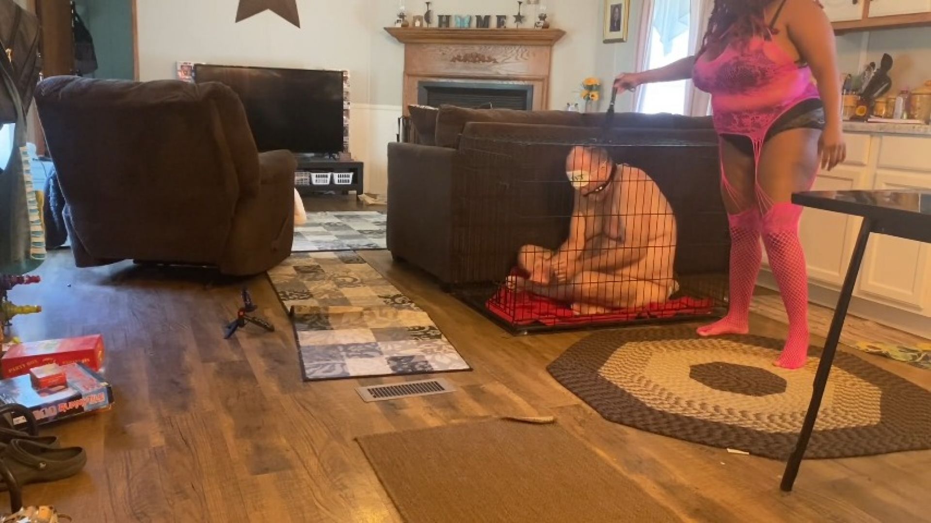 goddess and her minion play with slave in its cage