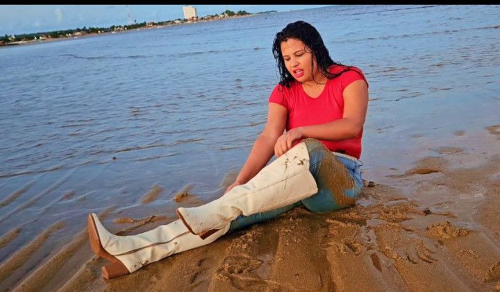 Wetlook in jeans, white boots and hair flipping in the sea