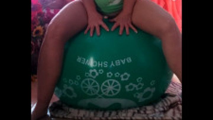 Playing with a green 36 inch balloon