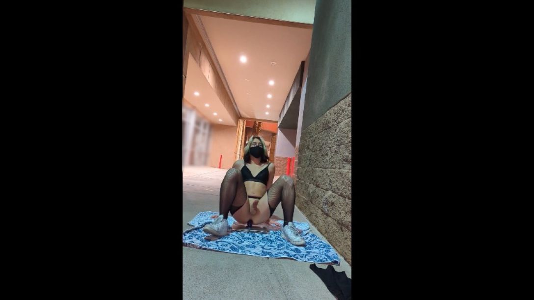 Femboy in lingerie riding dildo at public strip mall