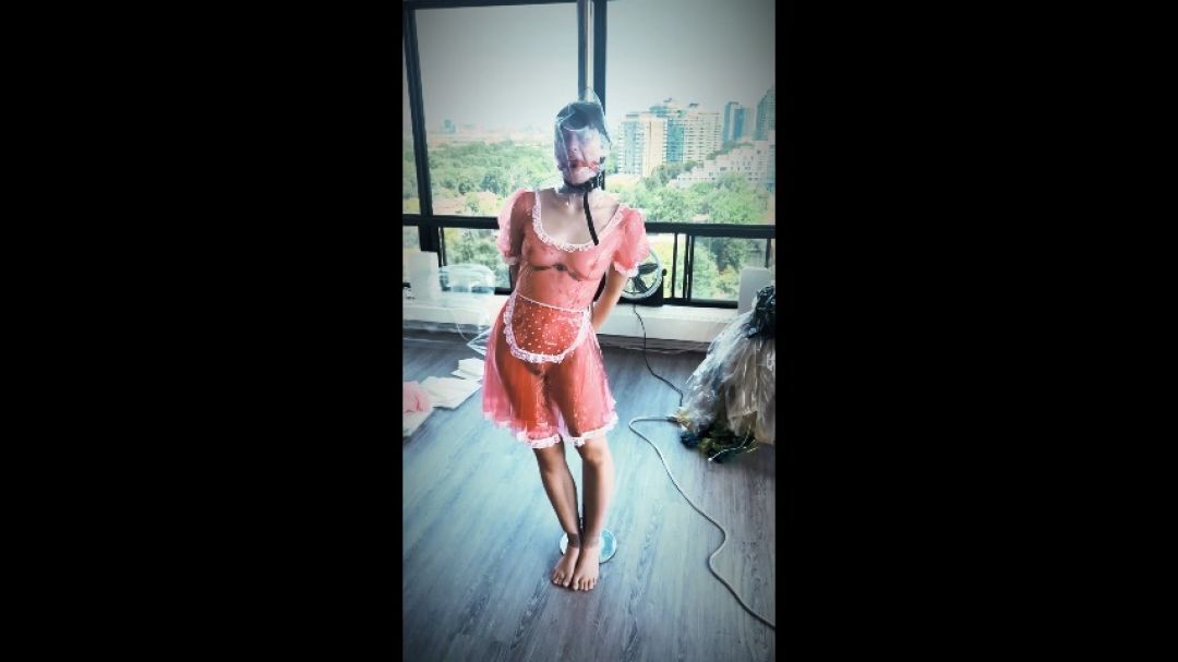 Lila Demonic hangs while bagged on a stripper pole