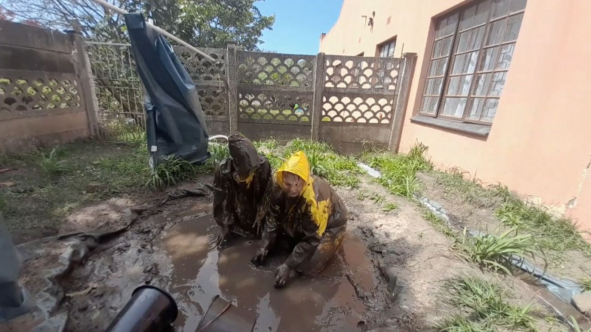 Tricked into a mud fight in rainwear