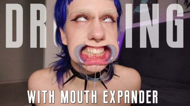 Goth girl's drooling &amp; rolling her eyes with mouth expander