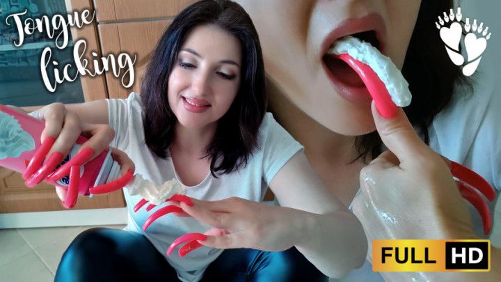 Tongue licking cream off long red nails