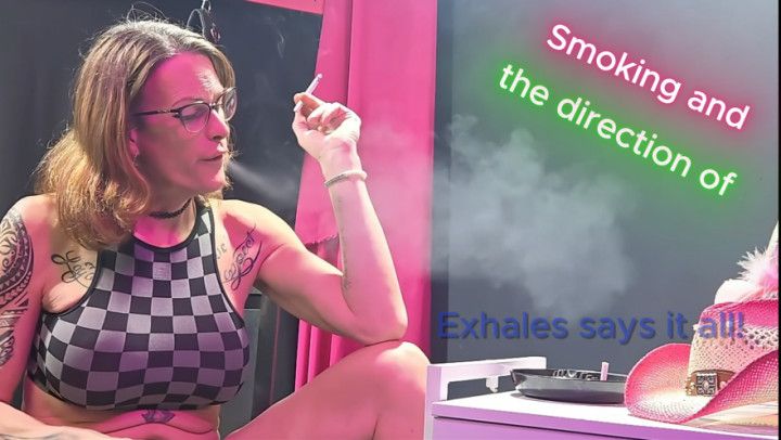 Her exhaled smoke playfully aiming the hat