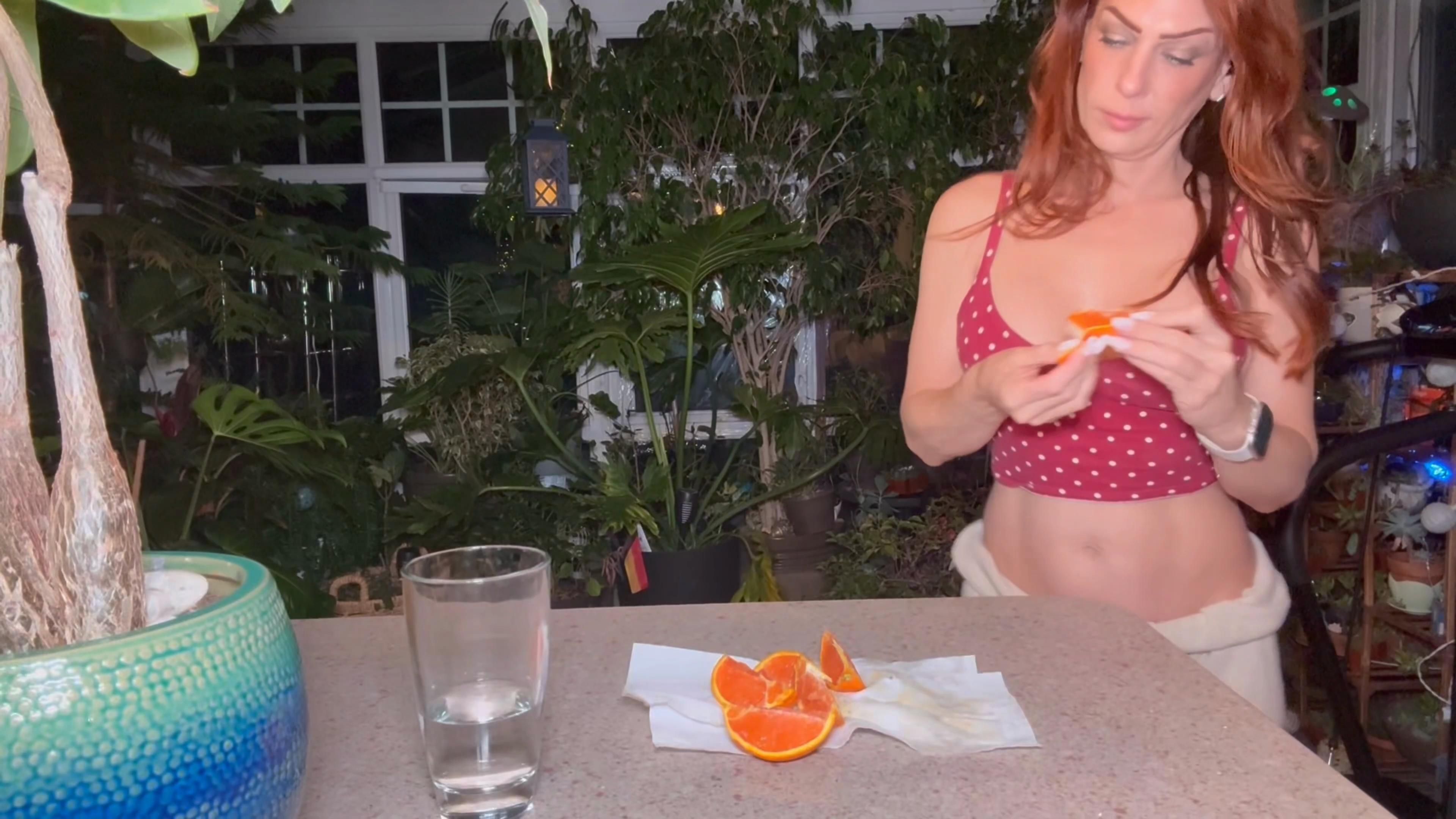 Sexy step Mommy eats an orange