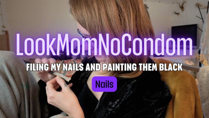 Filing my nails sharp and painting them black