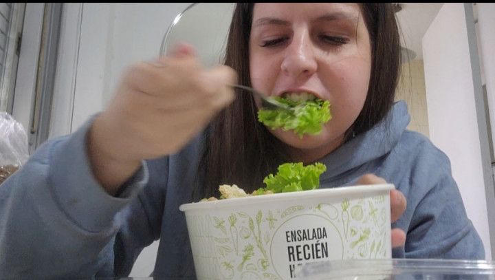 Chubby girl eating fresh salad gets angry