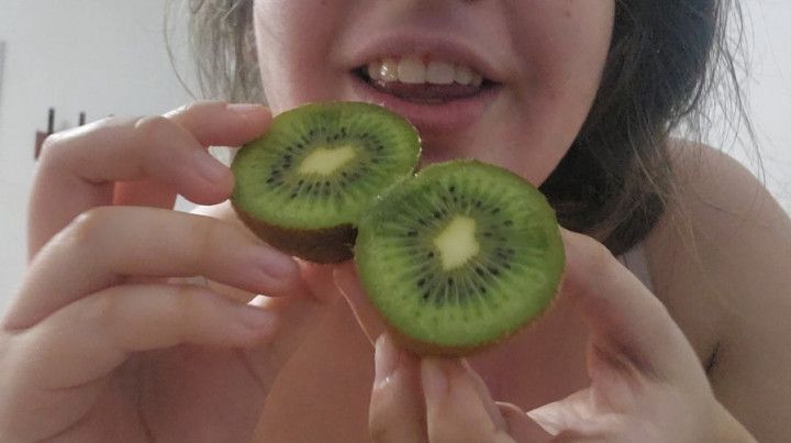 Chewing fetish eating a kiwi