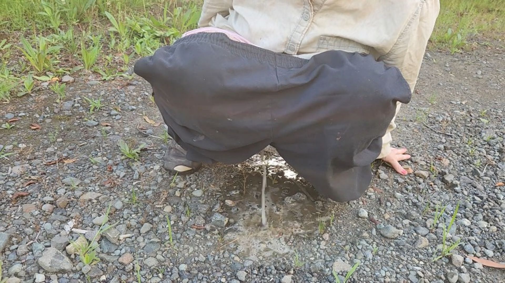 Desperate girl peeing on side of public road