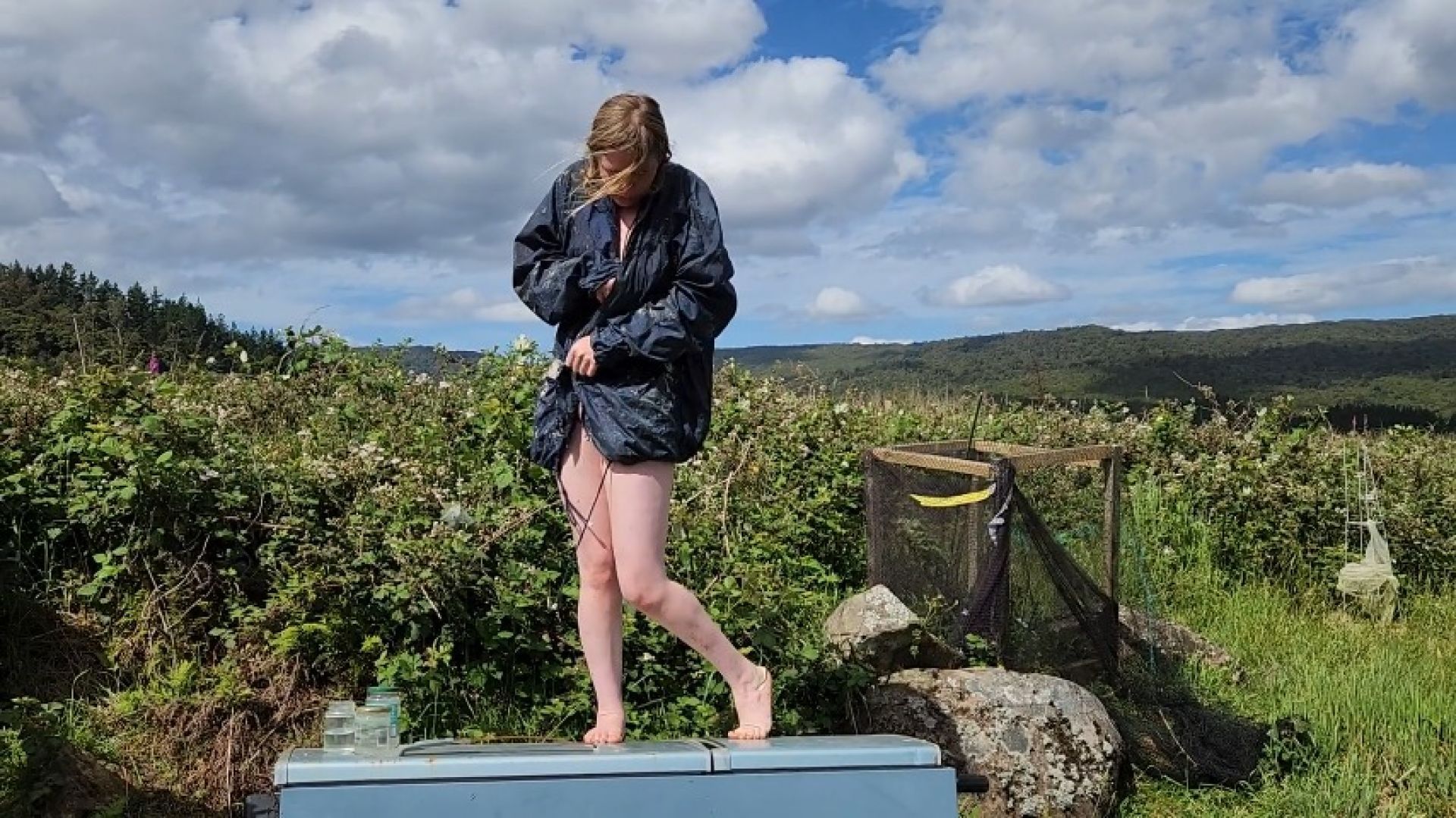 Girl made to wear only raincoat then strip and do tasks outs
