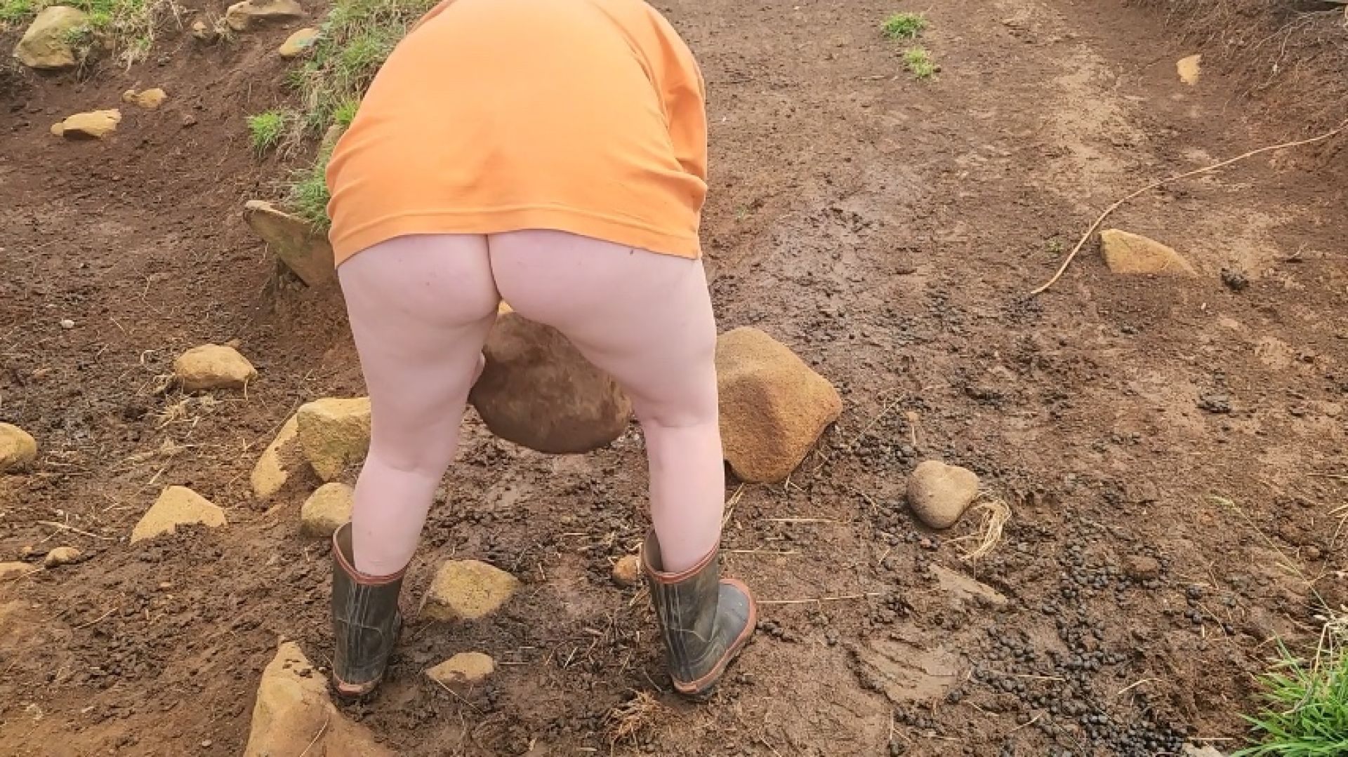 Petite girl without pants carrys heavy rocks