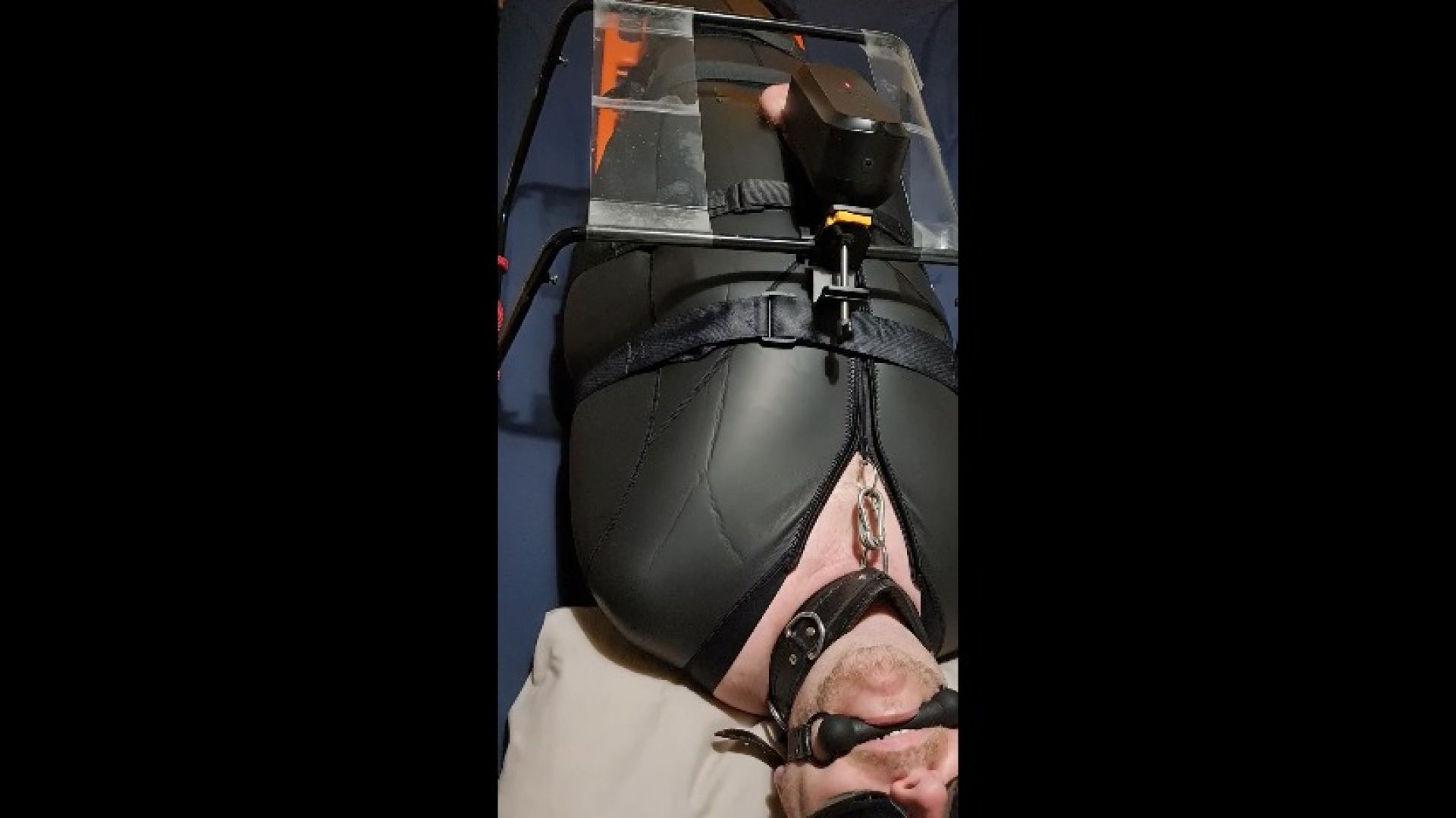 Miss M previews a male masturbator toy used on a man