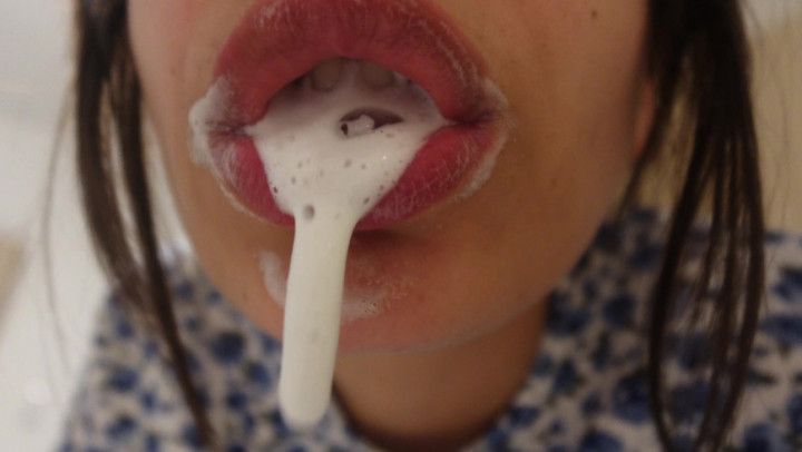 An Indian girl brushes her teeth and a lot of white fluid