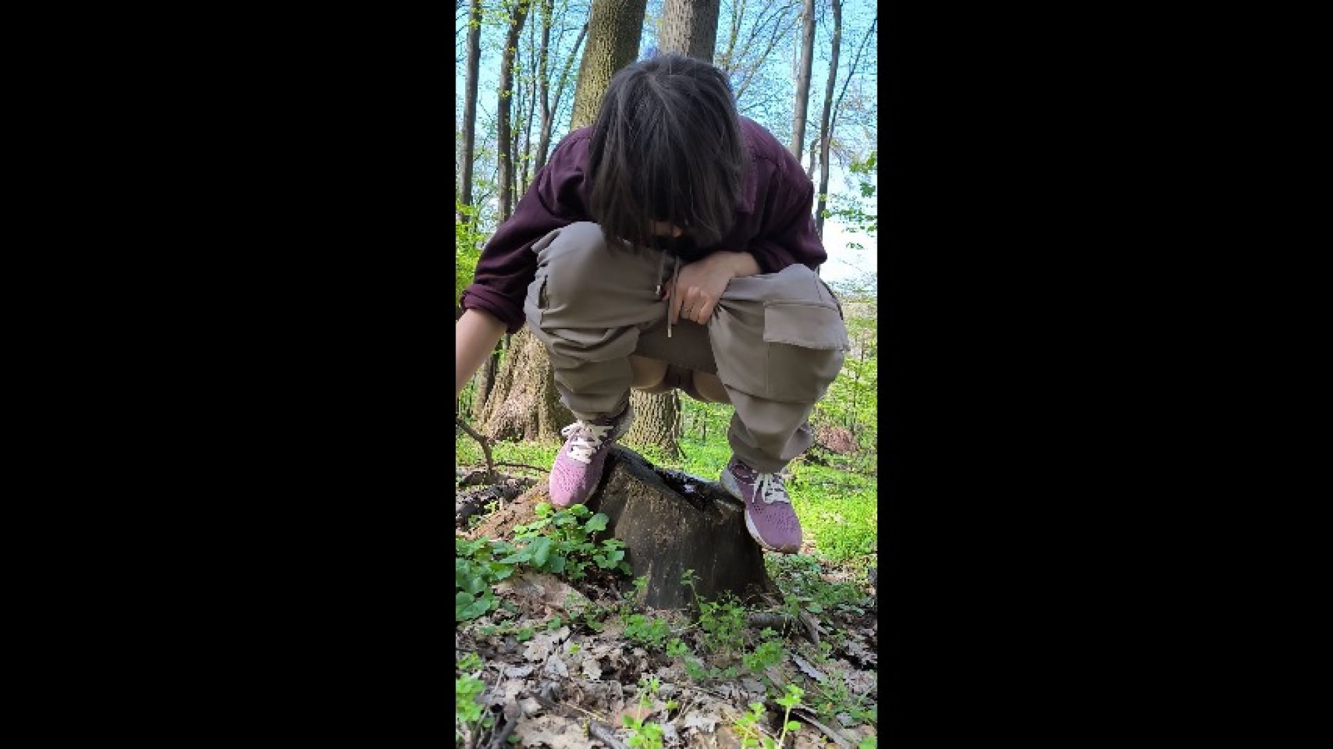 Manul girl is peeing in the hole of the stump