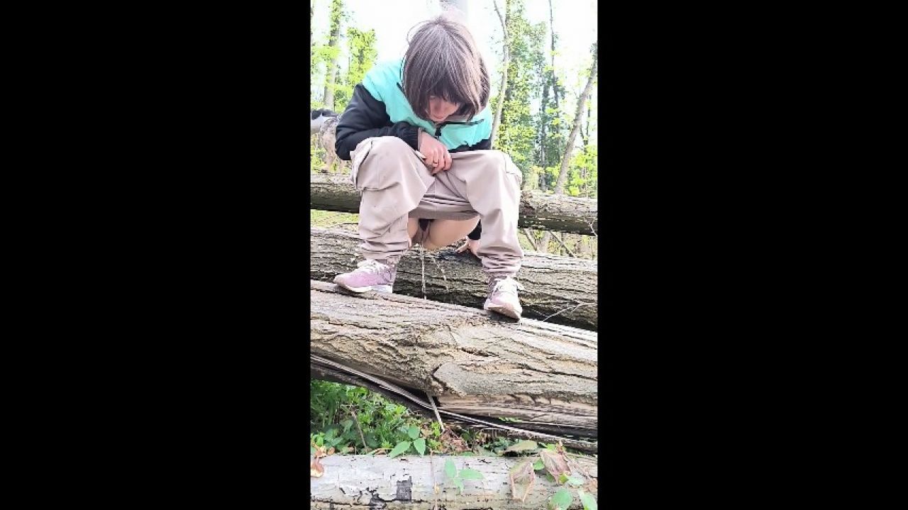 Manul girl pees on the big tree in the forest
