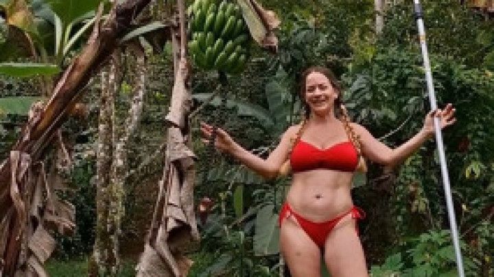Somer cuts down a banana tree in Costa Rica