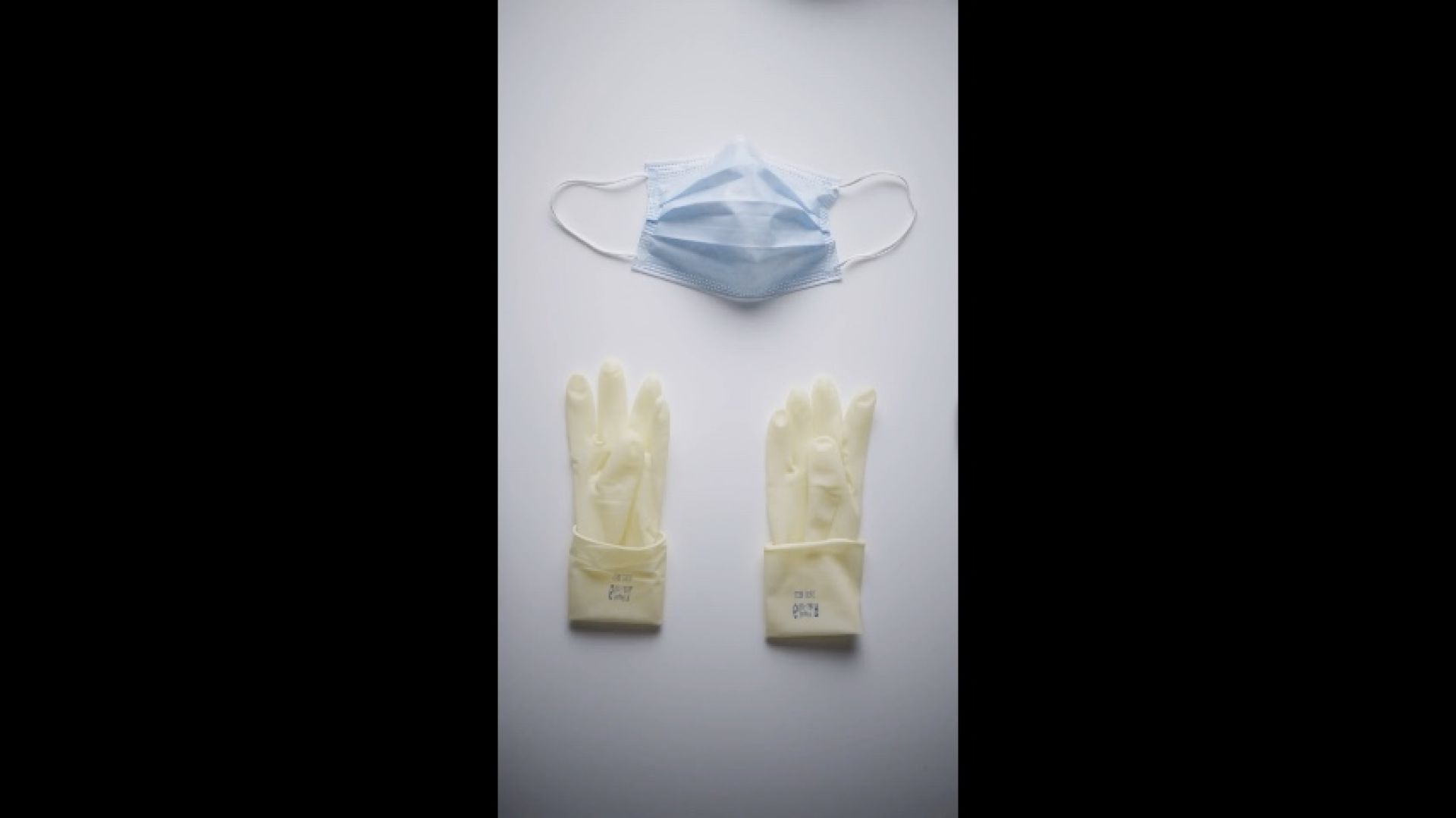 POV Putting on White Surgical Gloves and Mask